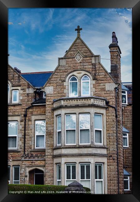 Victorian-style stone building with a gabled roof and bay windows under a blue sky with clouds, showcasing classic architectural details and craftsmanship in Harrogate, North Yorkshire. Framed Print by Man And Life