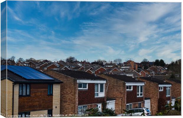 Suburban landscape with rows of British houses, featuring solar panels on roofs under a dynamic blue sky with wispy clouds in Harrogate, North Yorkshire. Canvas Print by Man And Life