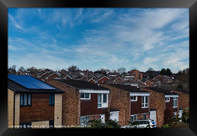 Suburban landscape with rows of British houses, featuring solar panels on roofs under a dynamic blue sky with wispy clouds in Harrogate, North Yorkshire. Framed Print by Man And Life