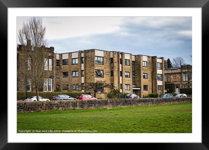 Modern residential apartment buildings with parked cars in front, behind a stone wall with a lush green lawn in the foreground. Urban living concept in Harrogate, North Yorkshire. Framed Mounted Print by Man And Life