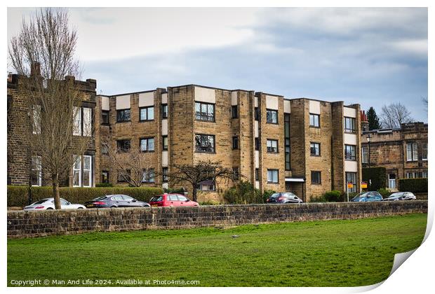 Modern residential apartment buildings with parked cars in front, behind a stone wall with a lush green lawn in the foreground. Urban living concept in Harrogate, North Yorkshire. Print by Man And Life