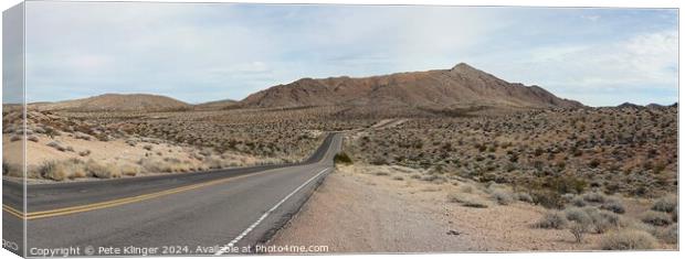 Valley of Fire highway, road into distant mountain Canvas Print by Pete Klinger
