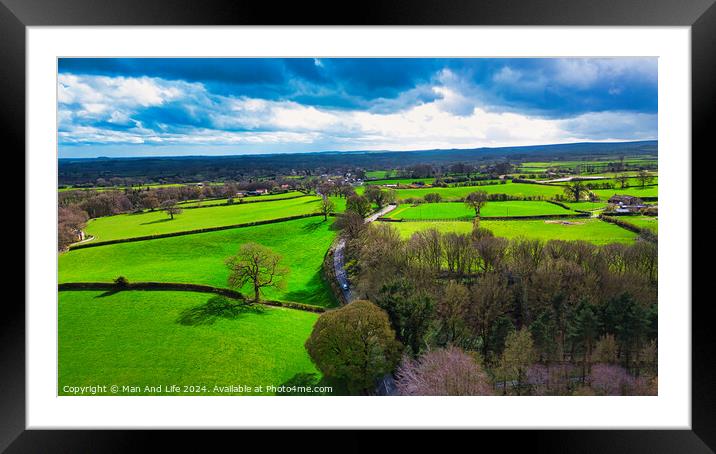Aerial view of lush green countryside with patchwork fields under a partly cloudy sky. Framed Mounted Print by Man And Life