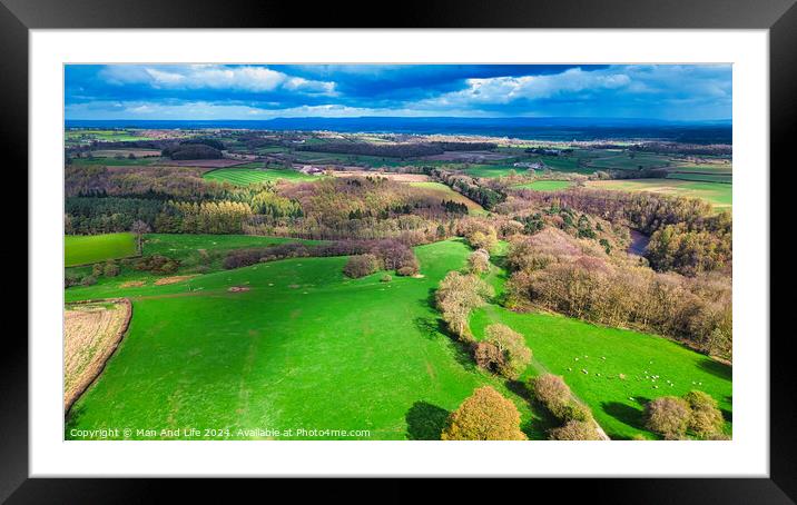 Aerial view of a vibrant rural landscape with lush green fields, patches of forests, and a clear view extending to the horizon under a partly cloudy sky. Framed Mounted Print by Man And Life