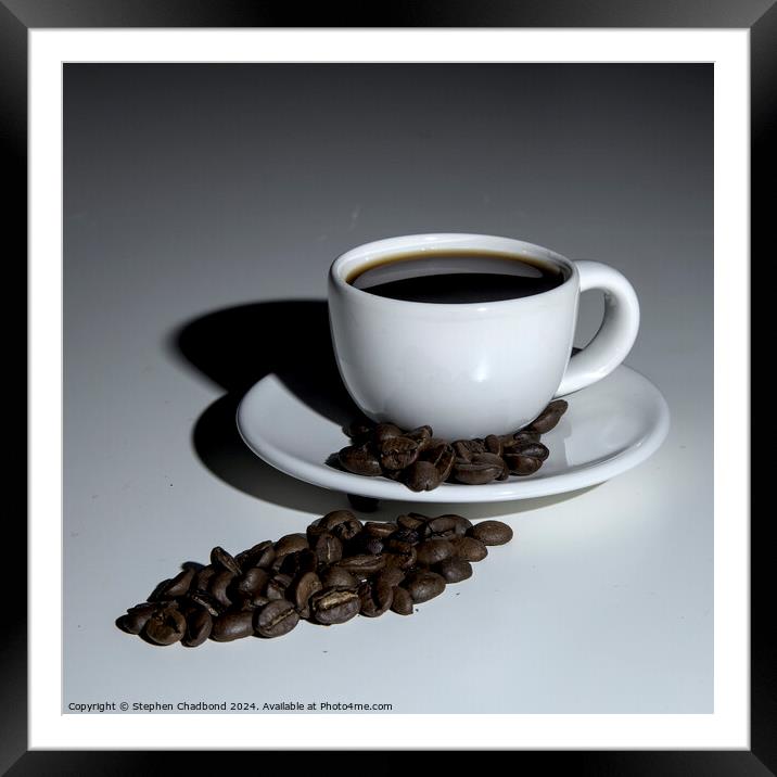 A cup of coffee on a white table. Framed Mounted Print by Stephen Chadbond