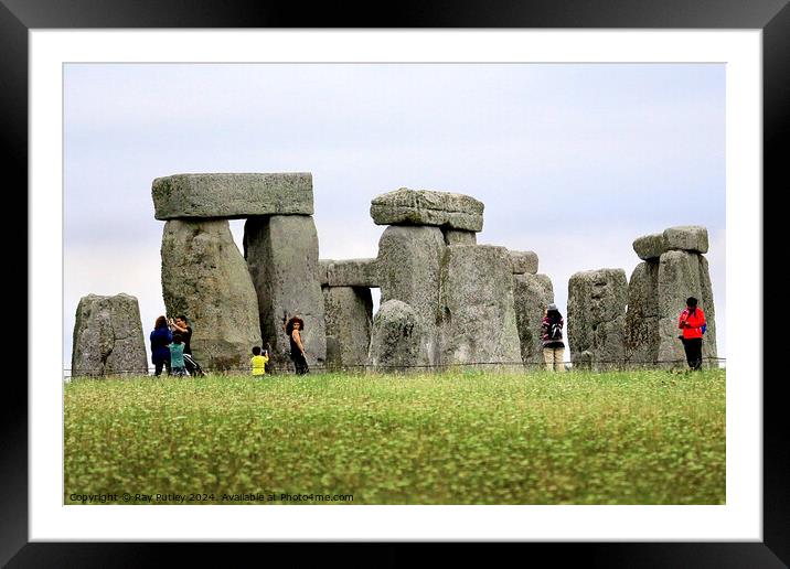 A group of people that are standing in the grass with Stonehenge in the background Framed Mounted Print by Ray Putley