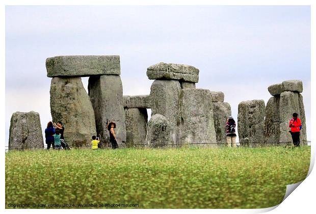 A group of people that are standing in the grass with Stonehenge in the background Print by Ray Putley