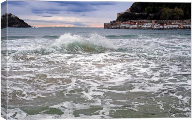 A wave breaks in the bay of San Sebastian, Spain Canvas Print by Lensw0rld 