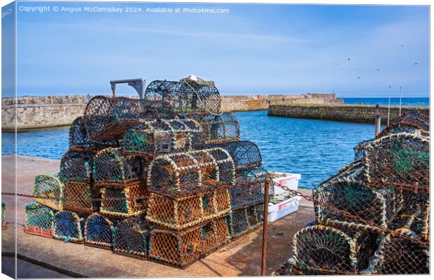 Lobster pots on quayside at St Andrews harbour Canvas Print by Angus McComiskey