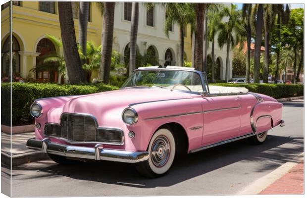 Pink convertible from the 70s in an avenue of palm trees. Canvas Print by Michael Piepgras
