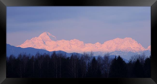 The distant Julian Alps aglow Framed Print by Ian Middleton