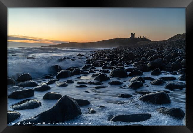 Boulder Beach and Dunstanburgh Castle at dawn Framed Print by Edward Bilcliffe