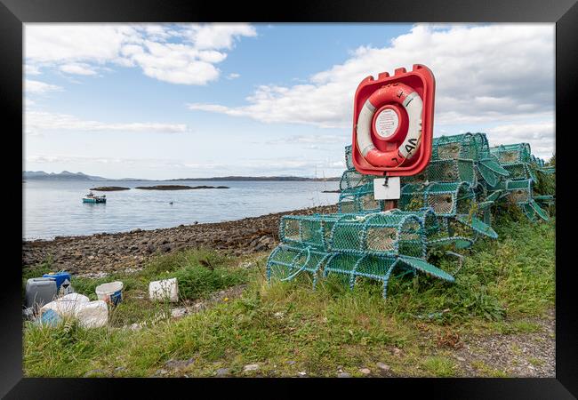 Lobster - crab pots stacked up around a life ring in Glenuig on the Sound of Arisaig, Highlands, Scotland Framed Print by Dave Collins