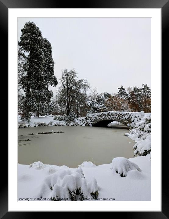 Old stone bridge and park lake in snow  Framed Mounted Print by Robert Galvin-Oliphant