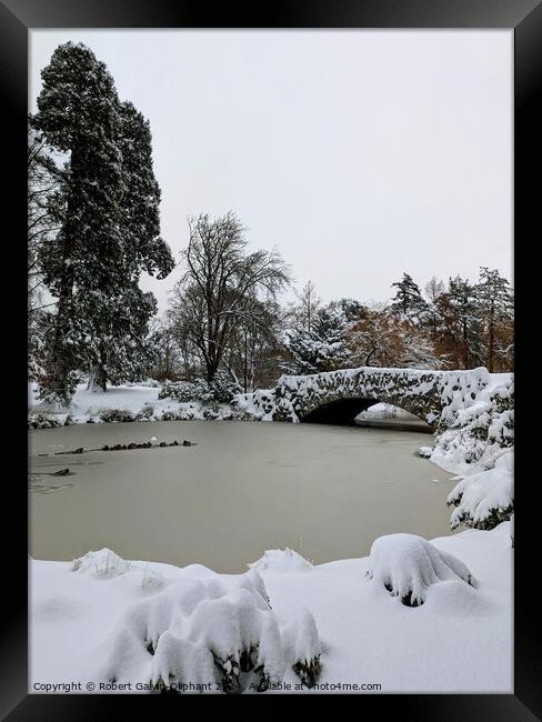 Old stone bridge and park lake in snow  Framed Print by Robert Galvin-Oliphant
