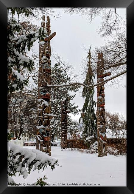 Totem poles in snow Framed Print by Robert Galvin-Oliphant