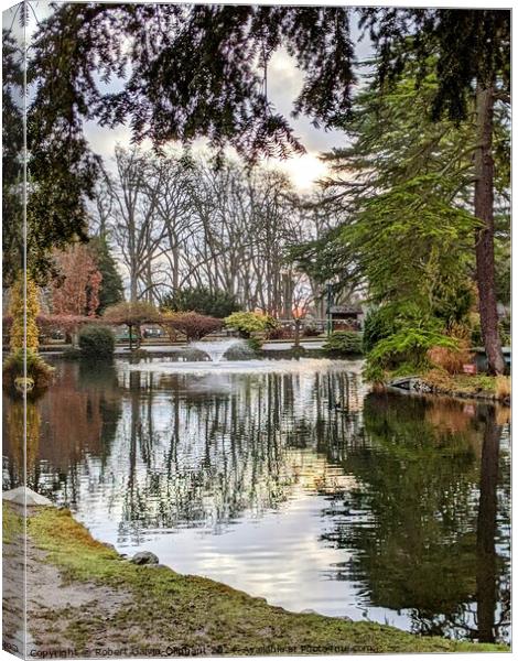 Tree reflections in park lake Canvas Print by Robert Galvin-Oliphant
