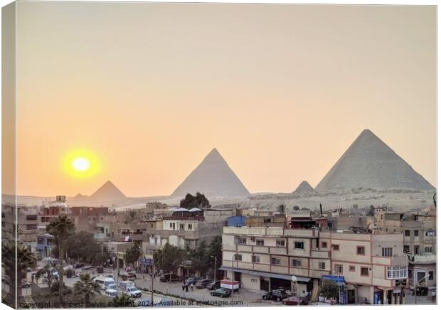 Setting sun at the pyramids of Giza Canvas Print by Robert Galvin-Oliphant
