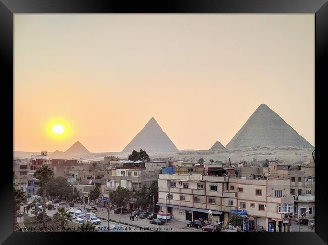 Setting sun at the pyramids of Giza Framed Print by Robert Galvin-Oliphant