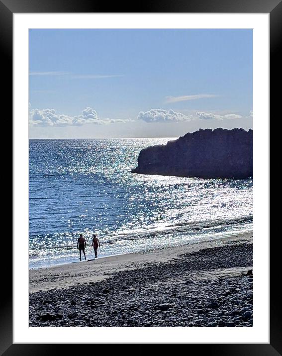 A couple walking on a black beach Framed Mounted Print by Robert Galvin-Oliphant