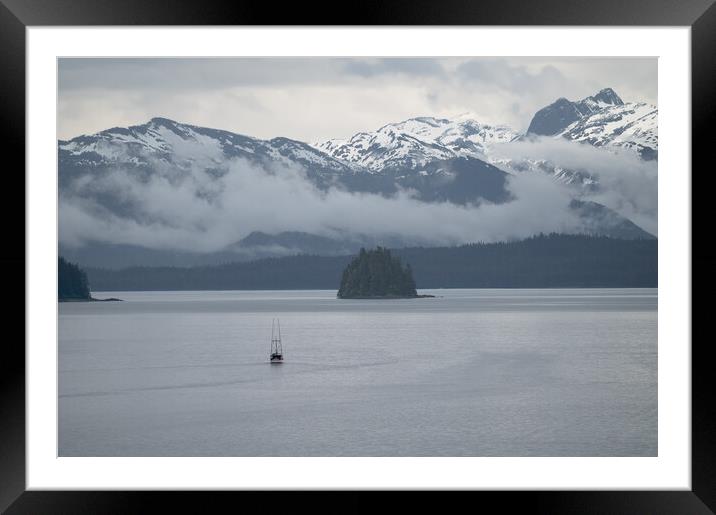 Commercial fishing boat  in Frederick Sound near Petersburg with clouds around the mountains beyond, Alaska, USA Framed Mounted Print by Dave Collins