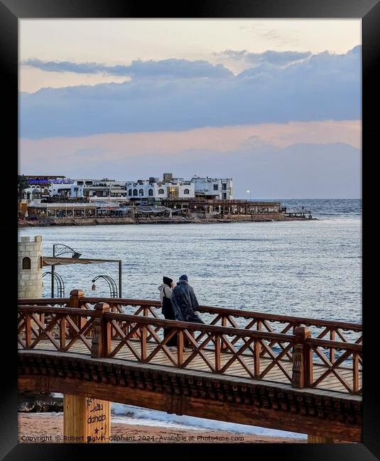 A couple on bridge looking out to sea Framed Print by Robert Galvin-Oliphant