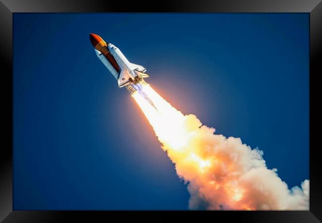 A powerful rocket launching into the sky leaving a trail of fire Framed Print by Michael Piepgras