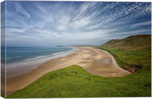 A landscape view of the beach at Rhossili Bay on the Gower Peninsula in Wales UK Canvas Print by John Gilham