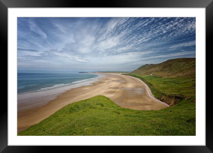 A landscape view of the beach at Rhossili Bay on the Gower Peninsula in Wales UK Framed Mounted Print by John Gilham