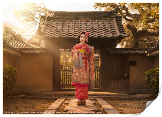 Maiko in a kimono posing on a stone path in front of the gate of a traditional Japanese house surrounded by cherry blossoms and pine trees in the rays of sunset. Print by  Kuremo