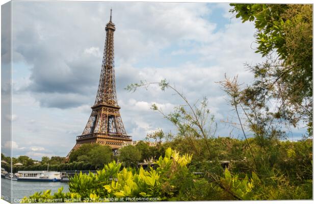 Eiffel Tower viewed from the banks with frame of vegetation Canvas Print by Laurent Renault