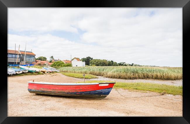Red and blue boat on the shore at Brancaster Staithe Framed Print by Jason Wells