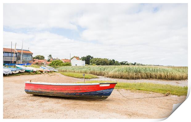 Red and blue boat on the shore at Brancaster Staithe Print by Jason Wells