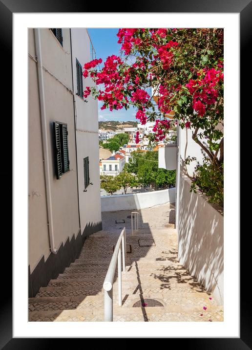 Steep street with Bougainvillea flowers, Albufeira, Portugal Framed Mounted Print by Kevin Hellon