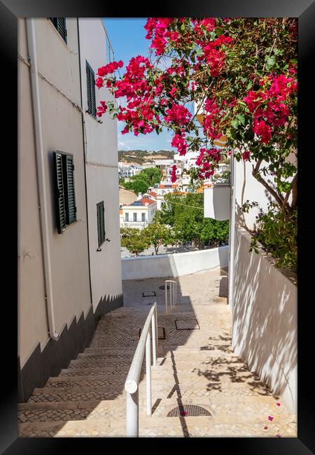 Steep street with Bougainvillea flowers, Albufeira, Portugal Framed Print by Kevin Hellon