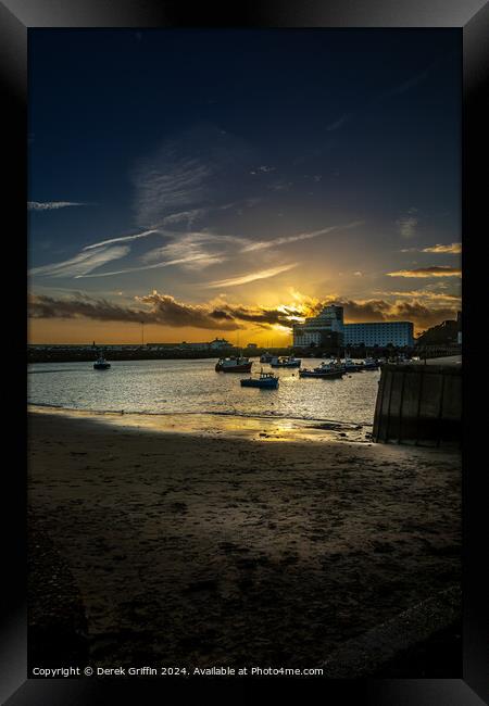 Folkestone Harbour sunset Framed Print by Derek Griffin