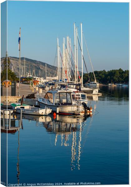 Boats moored in Stari Grad harbour, Croatia Canvas Print by Angus McComiskey