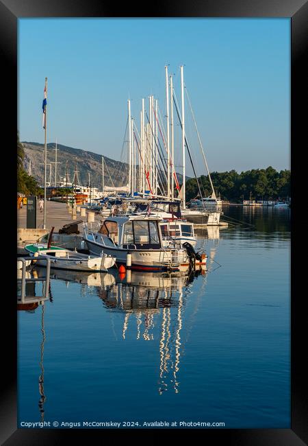 Boats moored in Stari Grad harbour, Croatia Framed Print by Angus McComiskey
