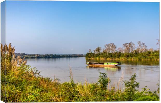 Wooden Boat on Mekong River Canvas Print by Kevin Hellon