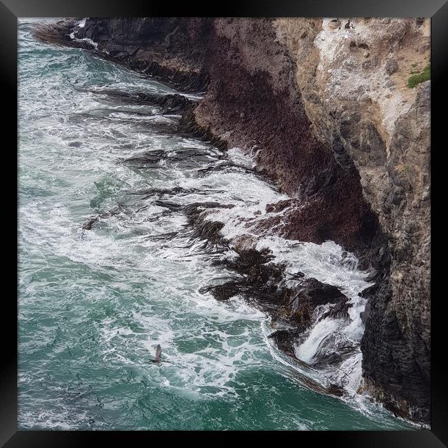 A sea waves hitting the cliff Framed Print by Junya Rawson