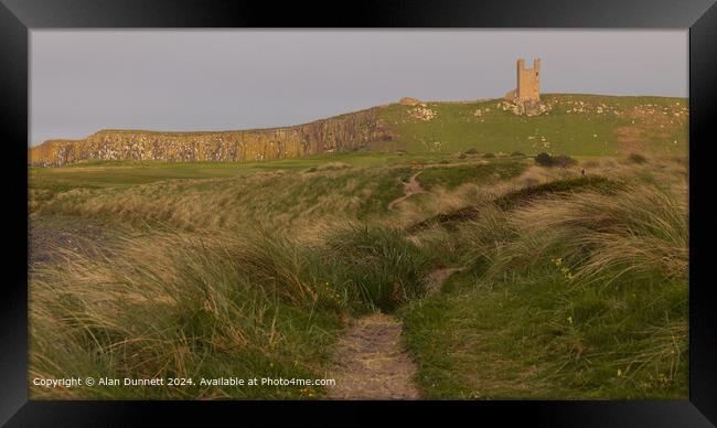 Dunstanburgh Castle Sunset Cliffs Framed Print by Alan Dunnett