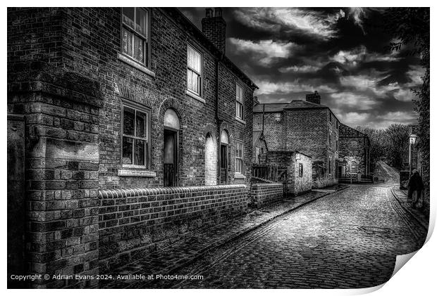 Victorian cobble stone street and shops England lit by lamps  Print by Adrian Evans