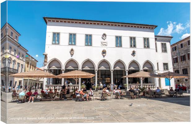Sunny outdoor cafe in front of historic building Canvas Print by Ronnie Reffin