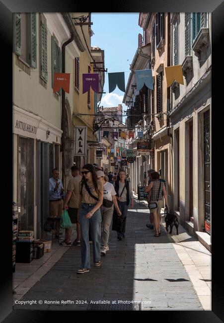 Old quaint alley in Koper bustling with tourists Framed Print by Ronnie Reffin