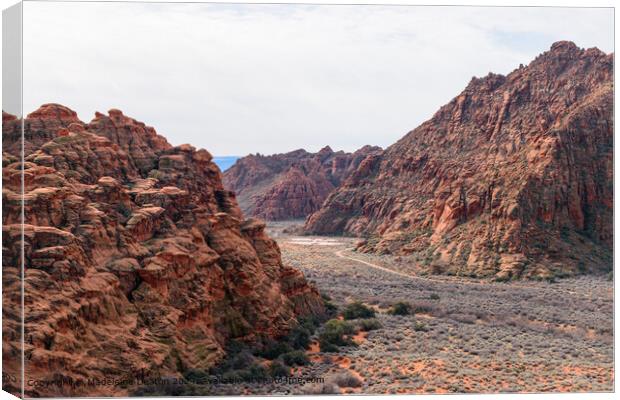 Aerial View of a Hiking Trail Surrounded by Red Rock Cliffs at Snow Canyon State Park Canvas Print by Madeleine Deaton