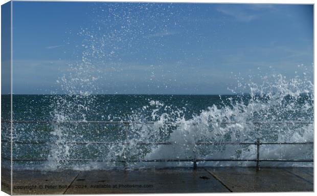 Wave breaking over the rail and concrete revetment at The Garrison, Shoeburyness, Essex. Canvas Print by Peter Bolton