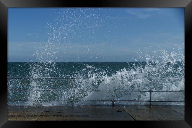 Wave breaking over the rail and concrete revetment at The Garrison, Shoeburyness, Essex. Framed Print by Peter Bolton