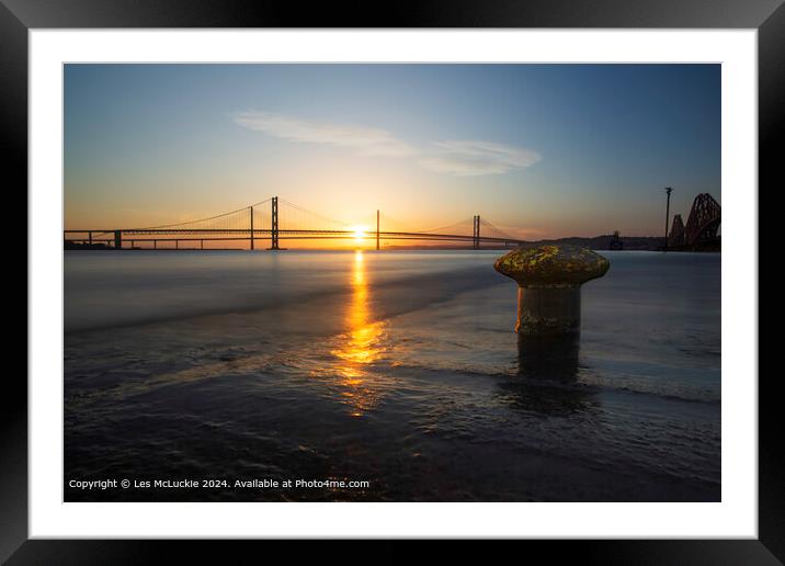 The forth Road Bridges at sunset from the shore at the rail bridge Framed Mounted Print by Les McLuckie