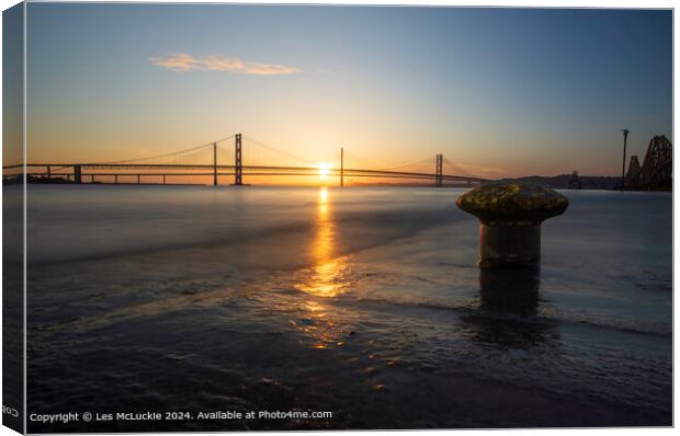 Sunset over the Forth Road Bridges from the rail bridge shoreline Canvas Print by Les McLuckie