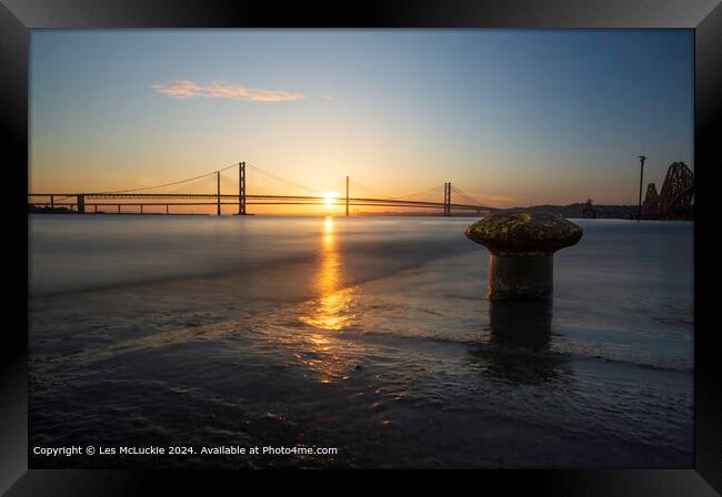 Sunset over the Forth Road Bridges from the rail bridge shoreline Framed Print by Les McLuckie